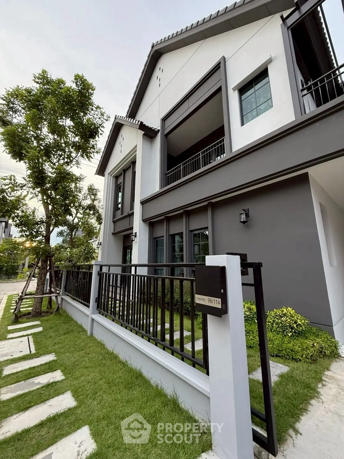 Modern two-story house with sleek design and lush green lawn