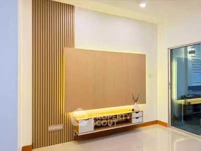 Modern living room with stylish wooden paneling and built-in shelving unit