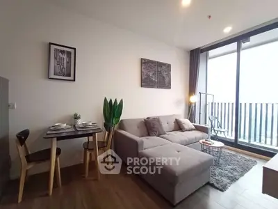 Modern living room with stylish decor and large balcony view