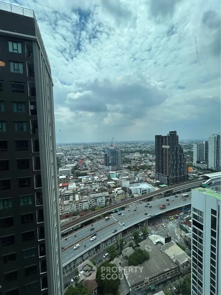 Stunning cityscape view from high-rise building with expansive skyline and bustling roads.