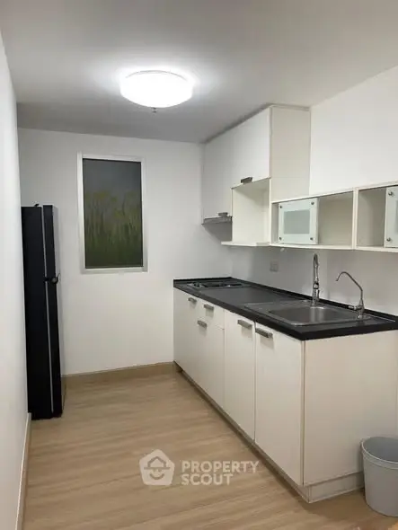 Modern minimalist kitchen with sleek cabinetry and wood flooring