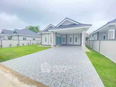 Charming modern house with spacious driveway and lush green lawn, perfect for family living.
