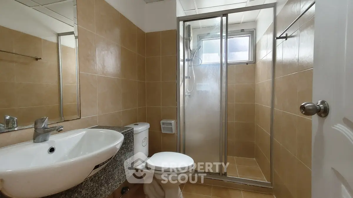 Modern bathroom with sleek shower and elegant fixtures in a stylish real estate property.