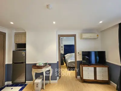 Charming studio apartment with modern furnishings and cozy bedroom area.
