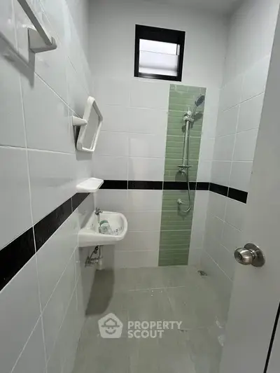 Compact bathroom with modern shower and minimalist design