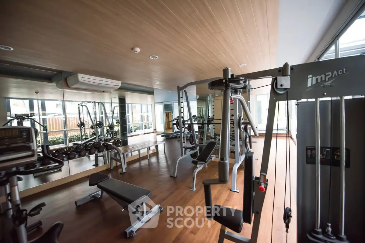 State-of-the-art gym facility in a modern residential complex with high-end equipment and a spacious layout, perfect for fitness enthusiasts.