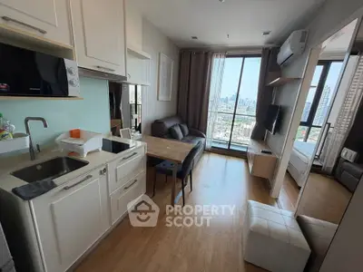 Modern open-plan living room with city view, featuring sleek kitchen and cozy seating area.