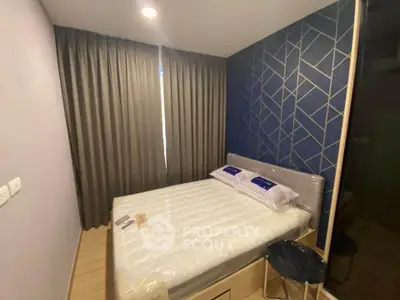 Modern bedroom with stylish geometric accent wall and cozy lighting