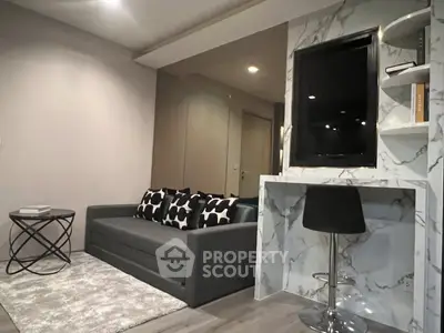 Modern living room with stylish marble accents and cozy seating area