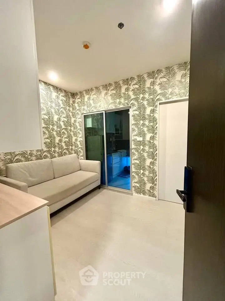 Chic modern living room with stylish wallpaper and cozy sofa, perfect for urban living.
