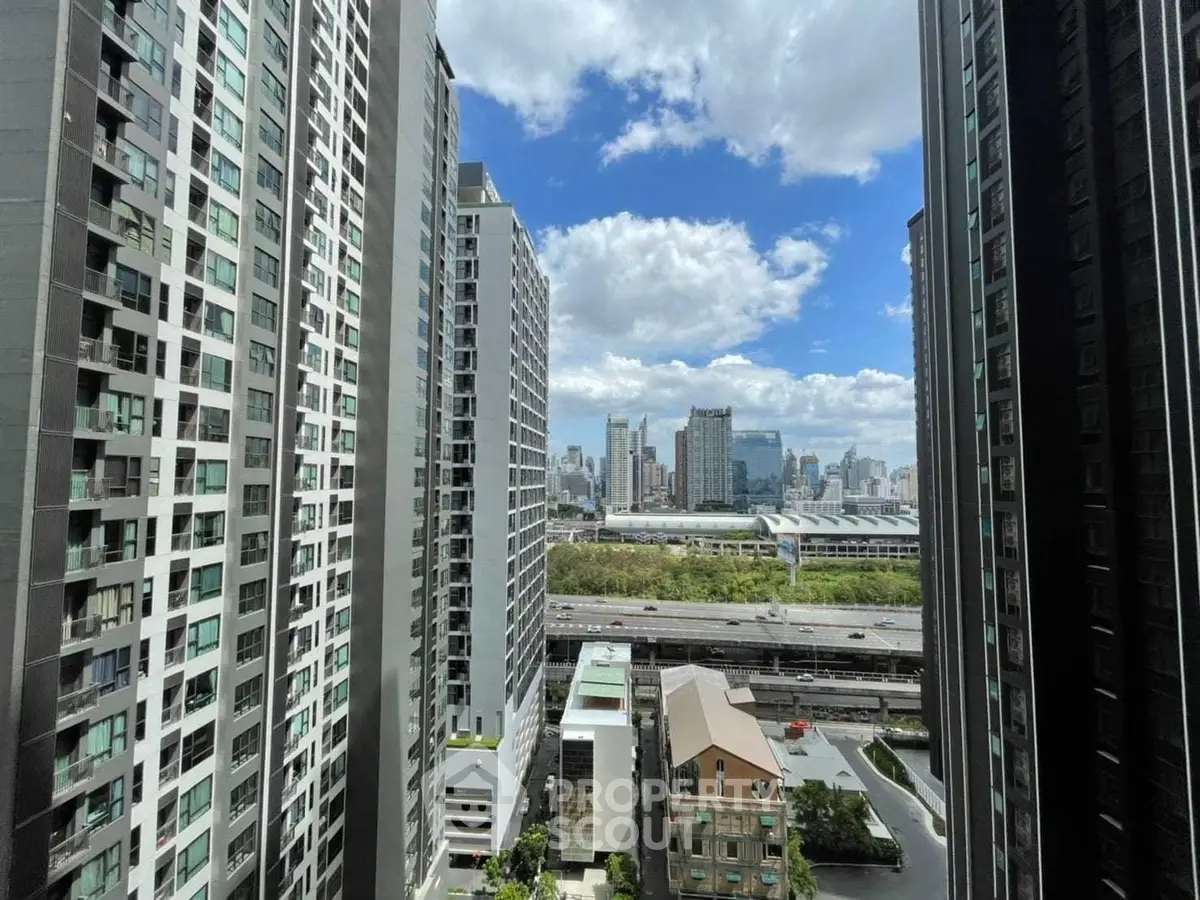 Stunning urban view from high-rise building with city skyline and blue sky.