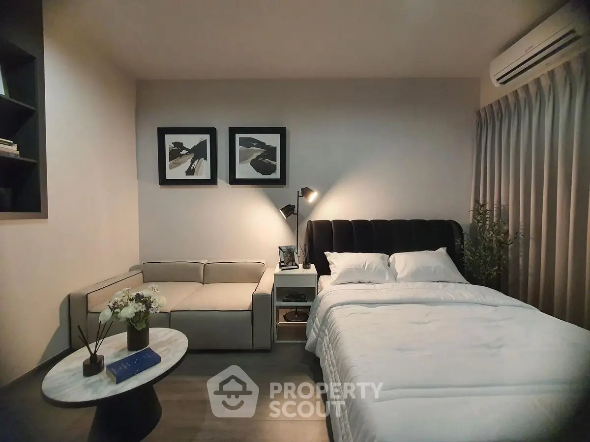Cozy bedroom with modern decor and comfortable seating area