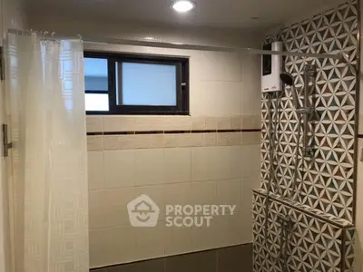 Charming bathroom with modern shower and geometric tile design