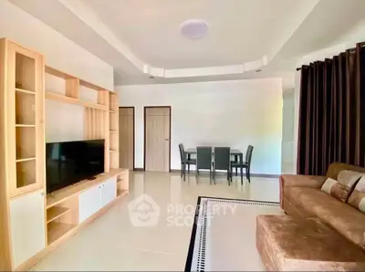 Spacious living room with modern furniture and entertainment center, perfect for relaxation and gatherings.