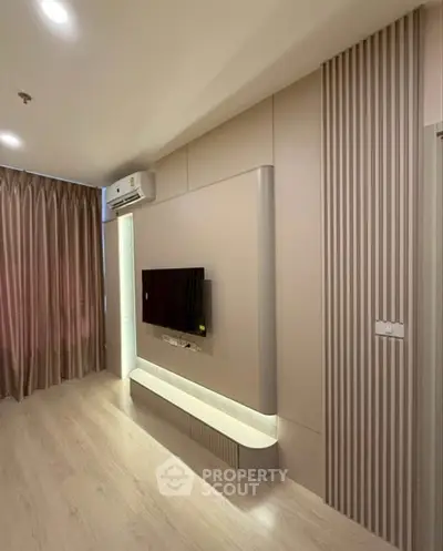 Modern living room with sleek TV setup and elegant curtains