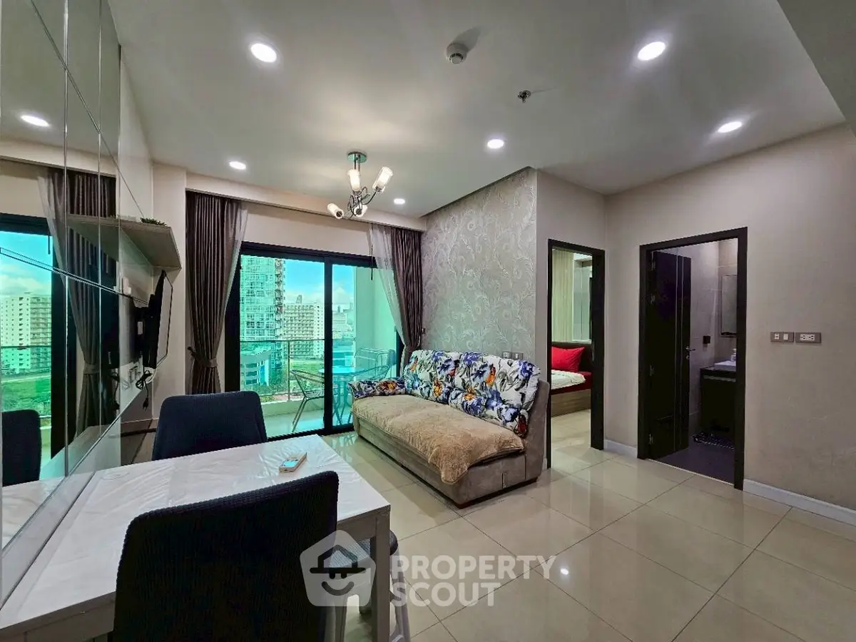 Modern living room with city view, stylish decor, and open layout in a high-rise apartment.
