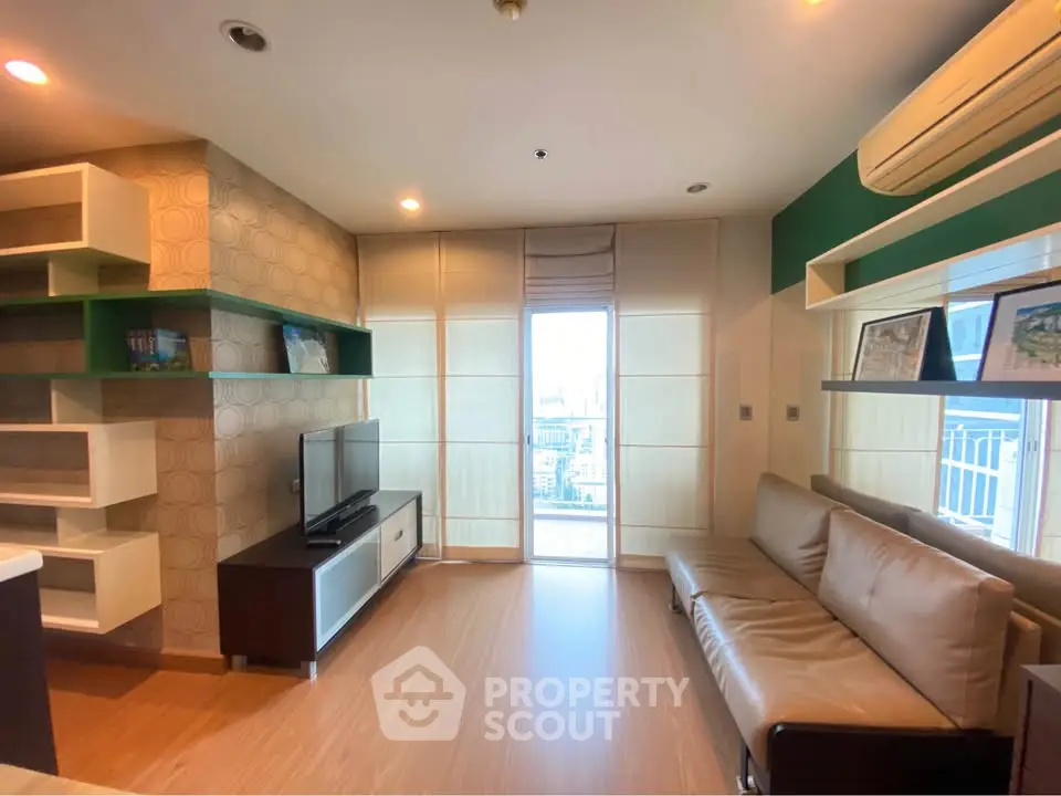 Modern living room with stylish decor and city view balcony access.