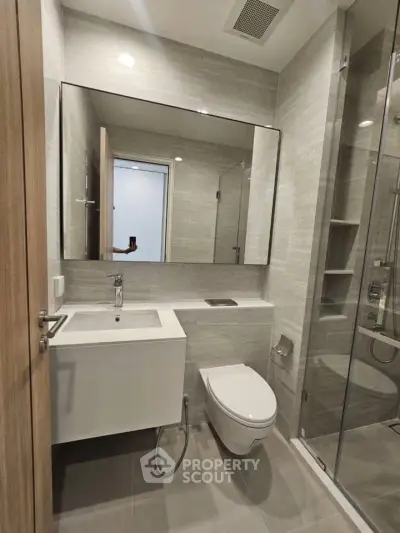 Modern bathroom with sleek fixtures and glass shower enclosure