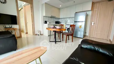 Modern open-plan kitchen and living area with sleek appliances and stylish furniture.