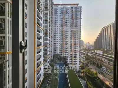 Stunning high-rise apartment view with pool and cityscape, perfect for urban living.