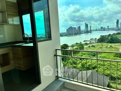 Stunning river view from modern apartment balcony with sleek kitchen design.