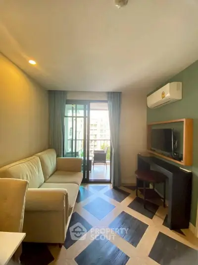Modern living room with balcony view, featuring stylish flooring and cozy seating area.