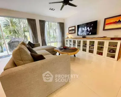 Spacious living room with modern decor and large windows for natural light