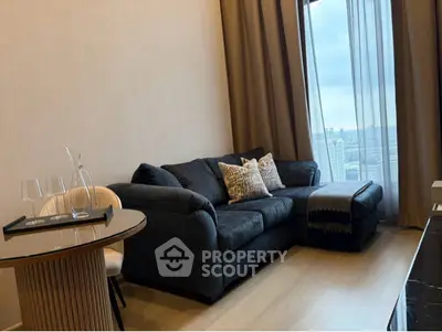 Modern living room with plush sofa and city view through large window
