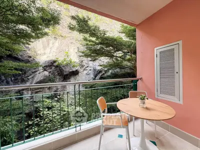 Charming balcony with scenic nature view, perfect for relaxation and outdoor dining.