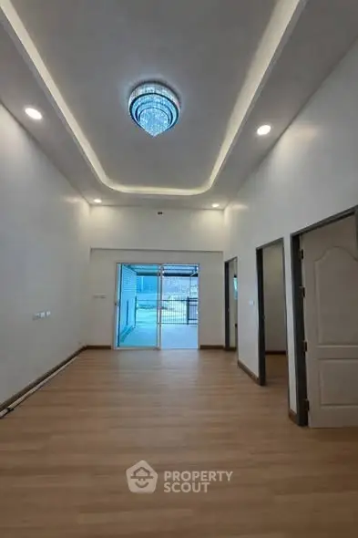 Spacious modern living room with elegant lighting and wooden flooring