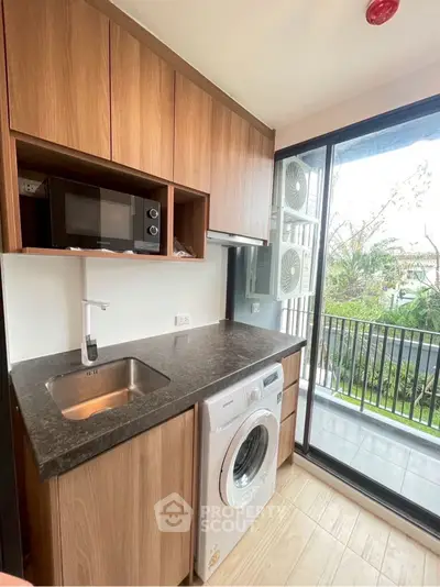 Modern kitchen with sleek countertops and built-in appliances in a stylish apartment.