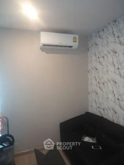 Cozy living room with modern air conditioning and stylish wallpaper.