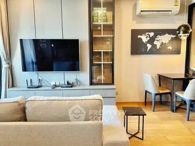 Modern living room with wall-mounted TV and stylish decor in a cozy apartment.