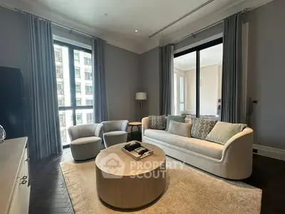 Elegant living room with modern furniture and large windows in luxury apartment.