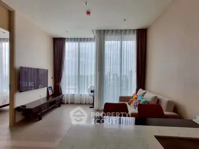 Spacious living room with large windows and city view