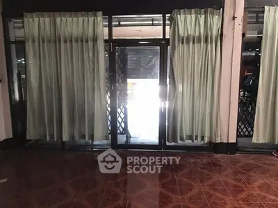 Spacious room with large windows and elegant curtains