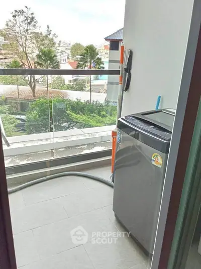 Charming balcony with washing machine and scenic view, perfect for urban living convenience.