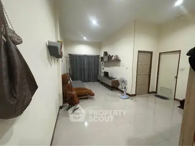 Spacious living room with modern decor and ample natural light, perfect for relaxation and entertainment.