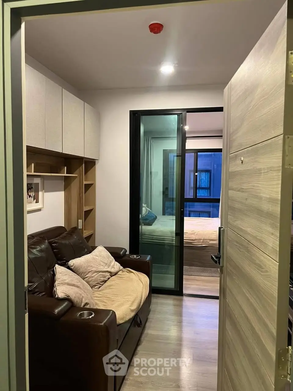 Cozy apartment entrance with modern living area and bedroom view