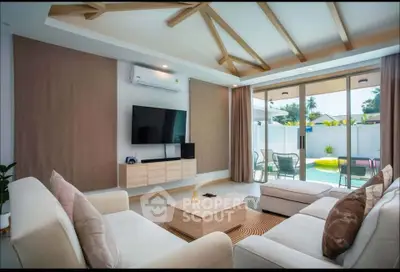 Luxurious living room with modern decor and pool view, perfect for relaxation and entertainment.