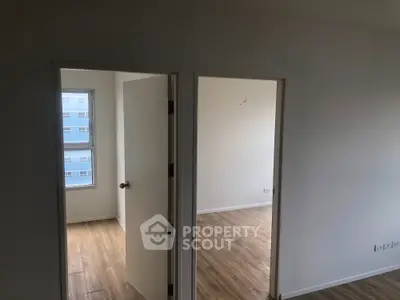 Spacious apartment interior with wooden flooring and natural light