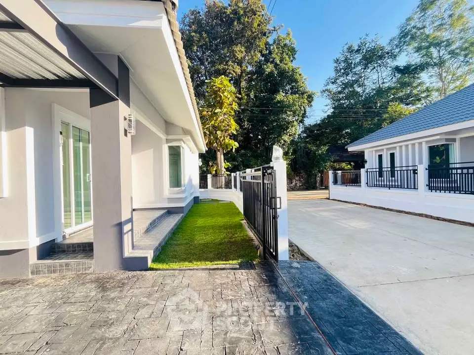 Charming modern home exterior with lush greenery and spacious driveway
