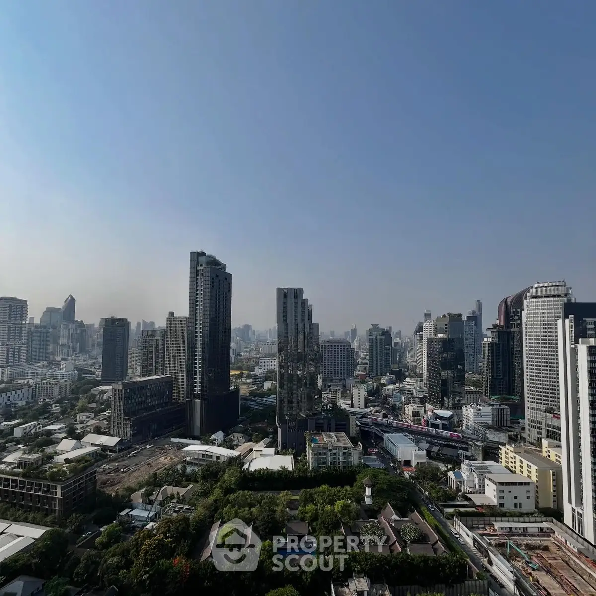 Stunning cityscape view showcasing modern skyscrapers and urban landscape under a clear blue sky.