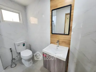 Modern bathroom with sleek fixtures and stylish wooden accents