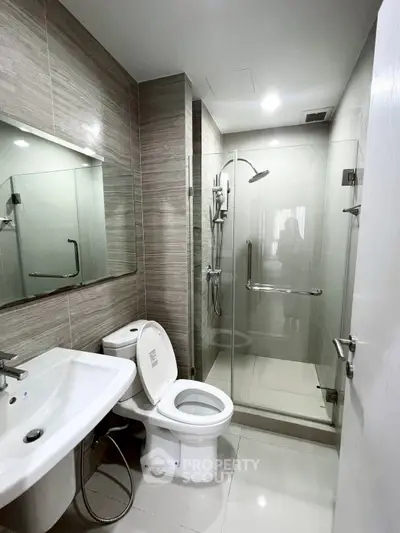 Modern bathroom with glass shower and sleek fixtures