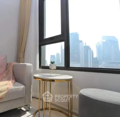 Modern living room with city view, elegant furniture, and natural light.