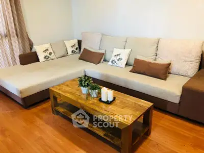 Cozy living room with stylish sectional sofa and wooden coffee table, perfect for relaxation.