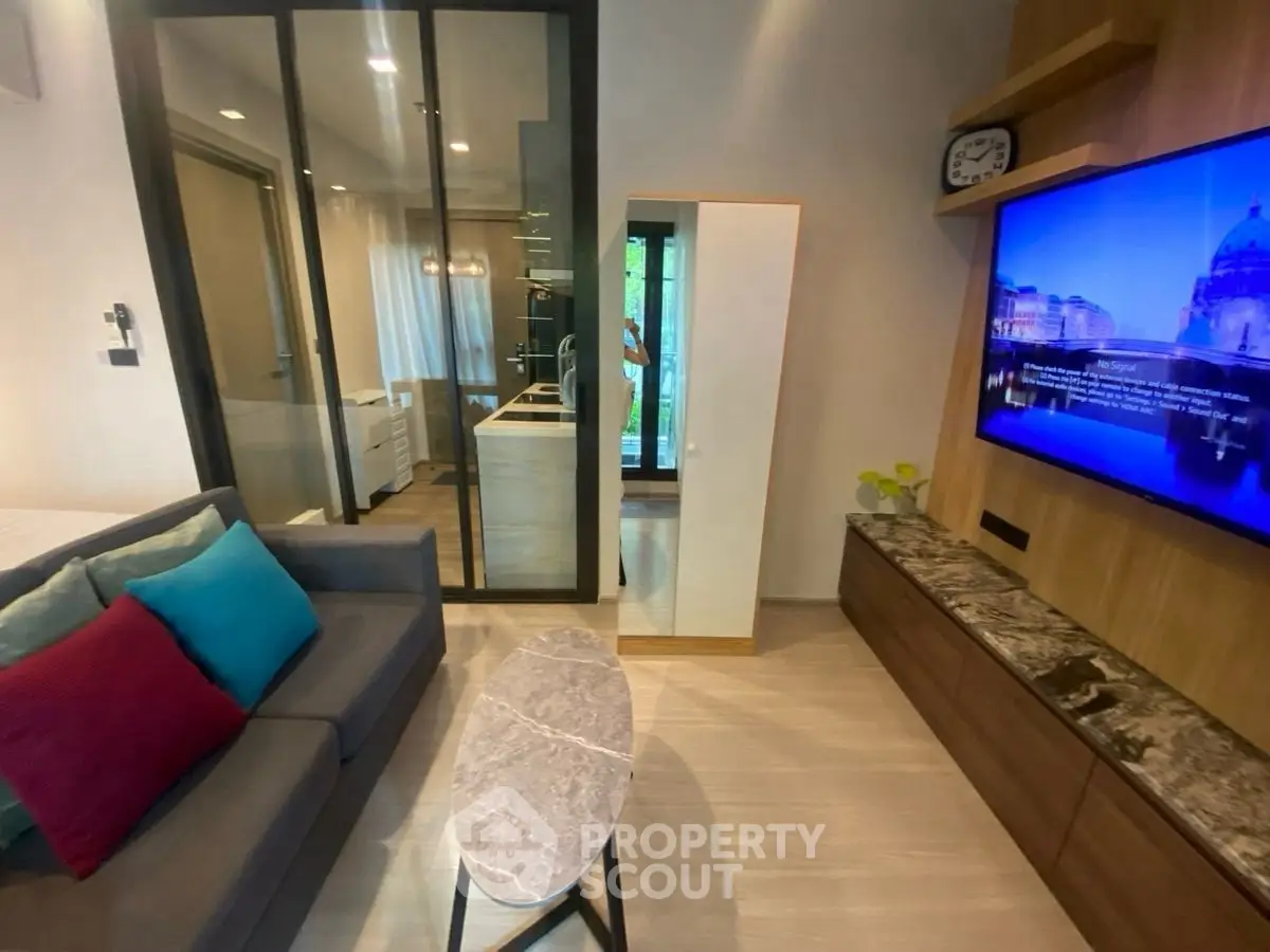 Modern living room with sleek design and open kitchen layout