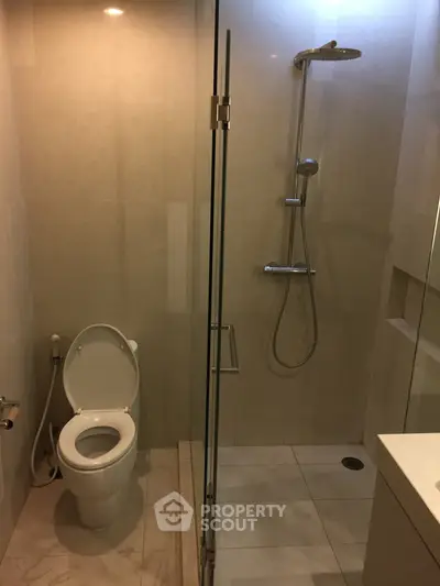 Modern bathroom with glass shower and toilet in a sleek design