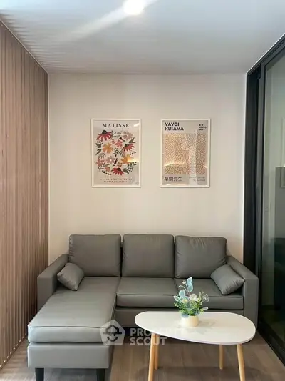 Modern living room with stylish gray sofa, wooden accents, and contemporary art decor.